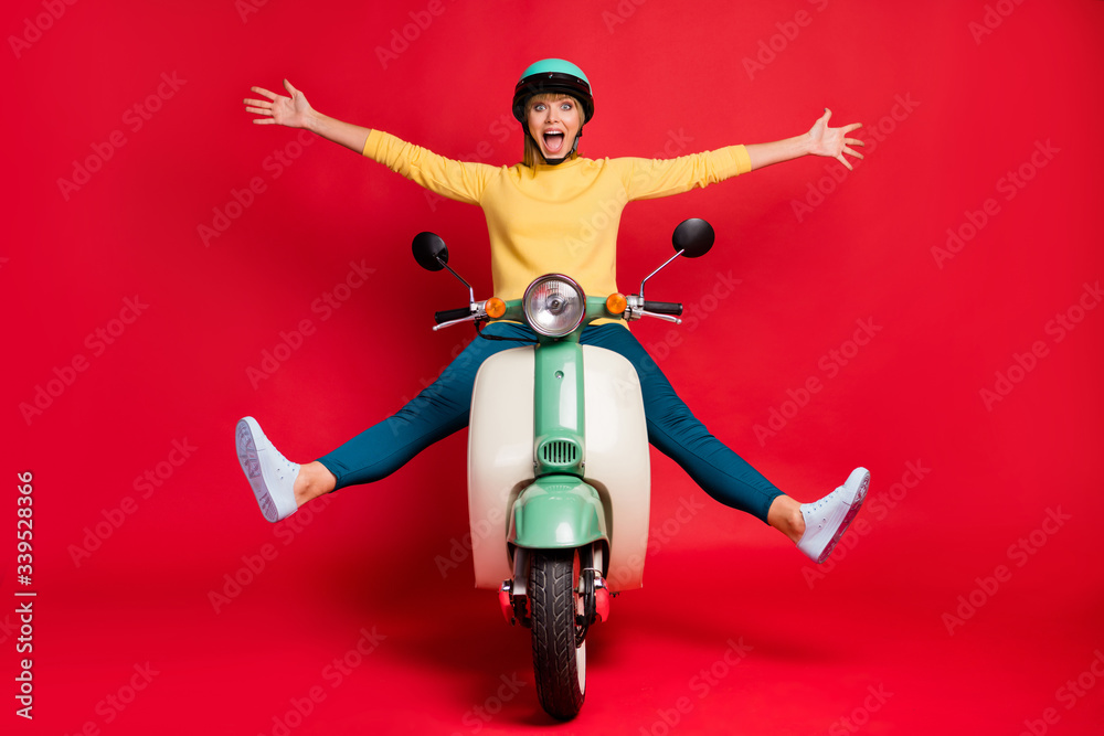 Canvas Prints Portrait of her she nice attractive carefree girlish crazy cheerful cheery girl riding moped without hand leg having fun adventure traveling isolated on bright vivid shine vibrant red color background