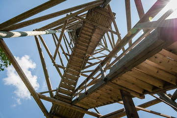 Close up view of observation tower with sunbeams. Viewing tower construction elements and stairs. Kamparkalns Hill. Latvia. Baltic.