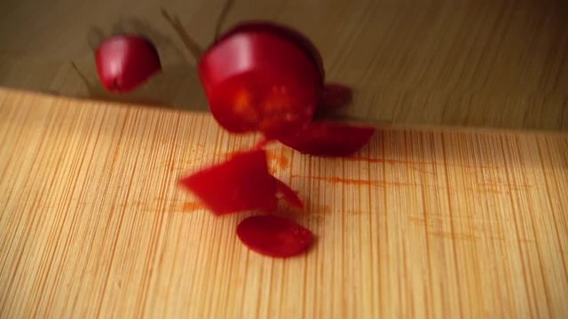 The cook cuts the capi pepper with a knife. Slow motion.