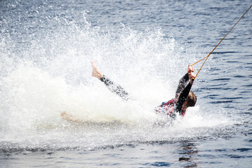 Obraz premium The guy in a thermosuit rides a board on water in the local river. Modern sport.