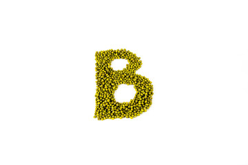 Green bean seed on white background, shaped B letter