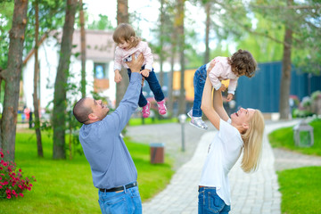 Fototapeta premium beautiful family walks in a flowered park