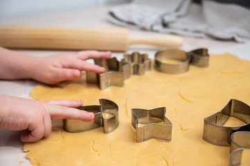 Fototapeta na wymiar Hands of young girl making butter cookies