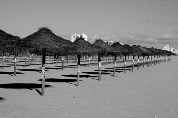 Closed beach in the Algarve because of the coronavirus. Umbrellas cast shadows, but not a single guest.