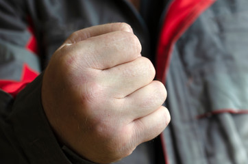 A clenched male fist.