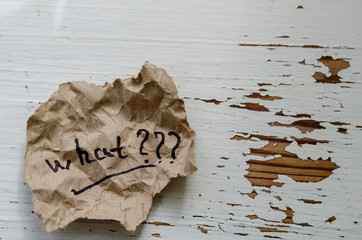 Crumpled paper with the question what.