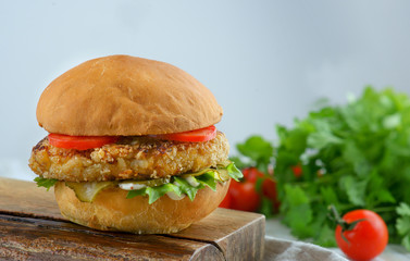 hamburger with chicken cutlet and tomatoes