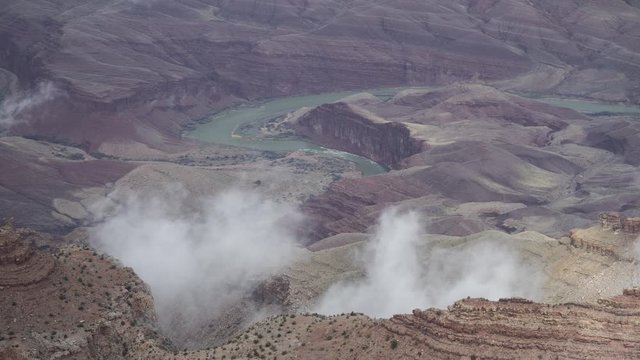 A beautiful long-lens timelapse of clouds flowing over goosenecks of the Colorado River inside the Grand Canyon.