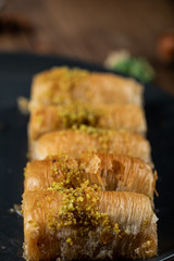 Turkish delight pakhlava served with minced pistacchio , angle view