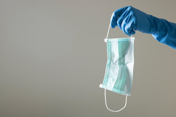 blue glove scientist protect virus bacteria contamination waste used surgical mask outbreak contagiuos disease covid19