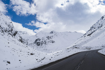 Fototapeta na wymiar mountains just snowed with road