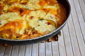 Vegetarian omelette  in a pan in the table 