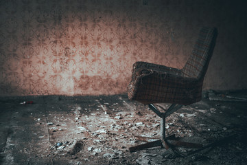 stary zniszczony fotel w opuszczonym budynku	
