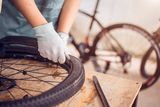 Bicycle tire care, Technician are fixing bicycle wheel, Close-up.