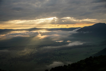 African savanna. The sun shines through the clouds in Serengeti National Park. Tanzania.