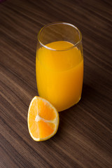 Jugo de nanja fresco con trozos de naranja sobre un fondo azul
