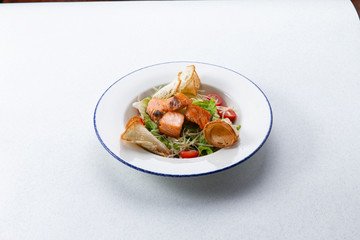 salad with slices of salmon in a plate