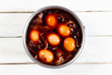 Boiling and painting eggs in onion peel in pot for easter
