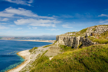 The cliffs of the Jurassic coast on the Isle of Portland, Portland, Dorset, UK on a hazy and sunny Summer morning