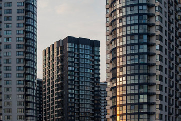 Fototapeta premium Modern and new apartment buildings. Multistoried modern, new and stylish living block of flats. Real estate. New house.Newly built block of flats