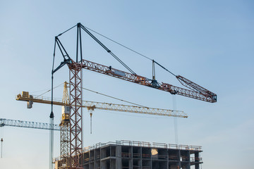 Fototapeta na wymiar construction site with cranes against the blue sky 