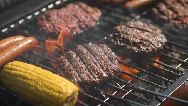 Mixed american barbecue food on hot grill