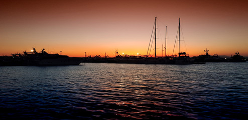 Sun going down in a Greek harbor