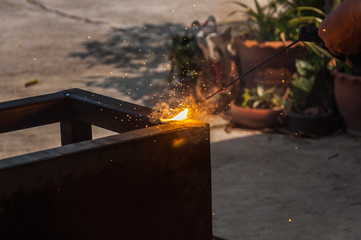 Workers welding metal in industrial plants