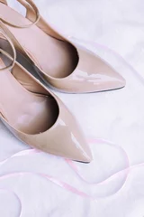 Foto auf Acrylglas beige patent shoes for girls with high heels © Анастасия Кузьменко