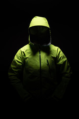 Green waterproof jacket  in static position with ghost effect and black background