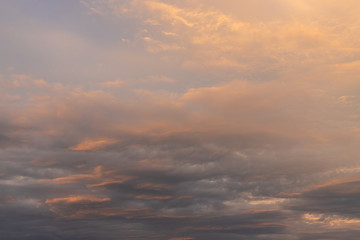 Naklejka na ściany i meble Layered clouds on the sky at sunset time.