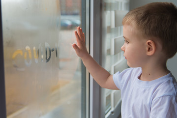 Cute boy Looking Through The Window