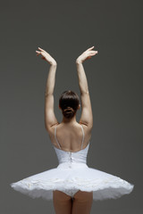 Fototapeta premium Young beautiful ballet dancer is posing in studio