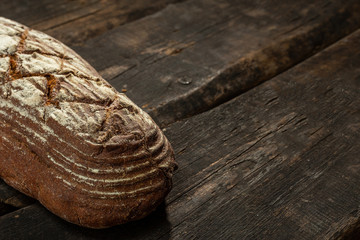 Fresh baked bread at wooden table