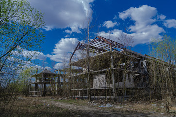 Fototapeta na wymiar Abandoned construction site of a residential complex. Skeletons of apartment buildings. Construction in progress. Bankruptcy of an investment construction company