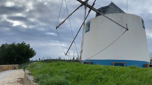 A traditional Portuguese windmill near the Algarve town of Odeceixe, Portugal. Panning upwards shot