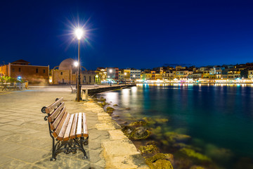 Fototapeta na wymiar Empty bench in the old Venetian port of Chania, Crete. Greece