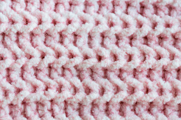 Close up of simple pink rib pattern textile wallpaper. Handmade pink knit warm cloth close up. Stitch knitted garment made of delicate wool yarn. Elegant textured material with woolly surface