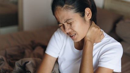 Obraz na płótnie Canvas Woman with neckache, asian woman suffering from neck pain 