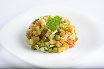 Dietary vitamin salad of boiled carrots, potatoes, eggs and canned green peas.