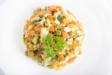 Top view. Dietary vitamin salad of boiled carrots, potatoes, eggs and canned green peas.