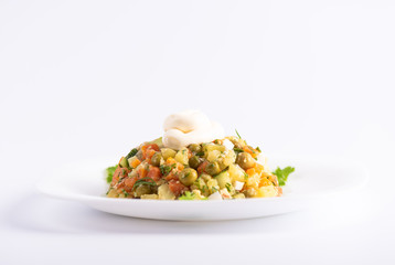 Selective focus. Dietary vitamin salad of boiled carrots, potatoes, eggs and canned green peas.