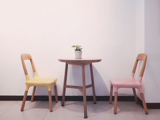 Vintage two chairs and wooden tablewith flowerpot.