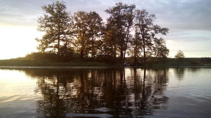 on the first background the river is transparent under the rays of the sun, on the second background the shore with trees and people