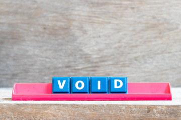 Tile letter on red rack in word void on wood background