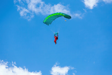 man flies on a parachute at the summer air show