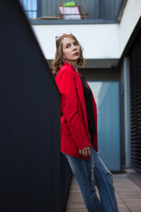 A young businesswoman thinking about something on her balcony
