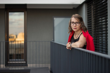 A young businesswoman thinking about something on her balcony
