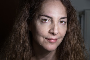 Portrait of a mature woman over 45 years old without makeup looking camera with confident expression.