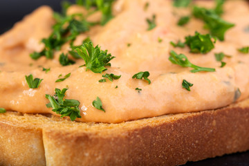 Tuna paste mixed with cocktail sauce on toast